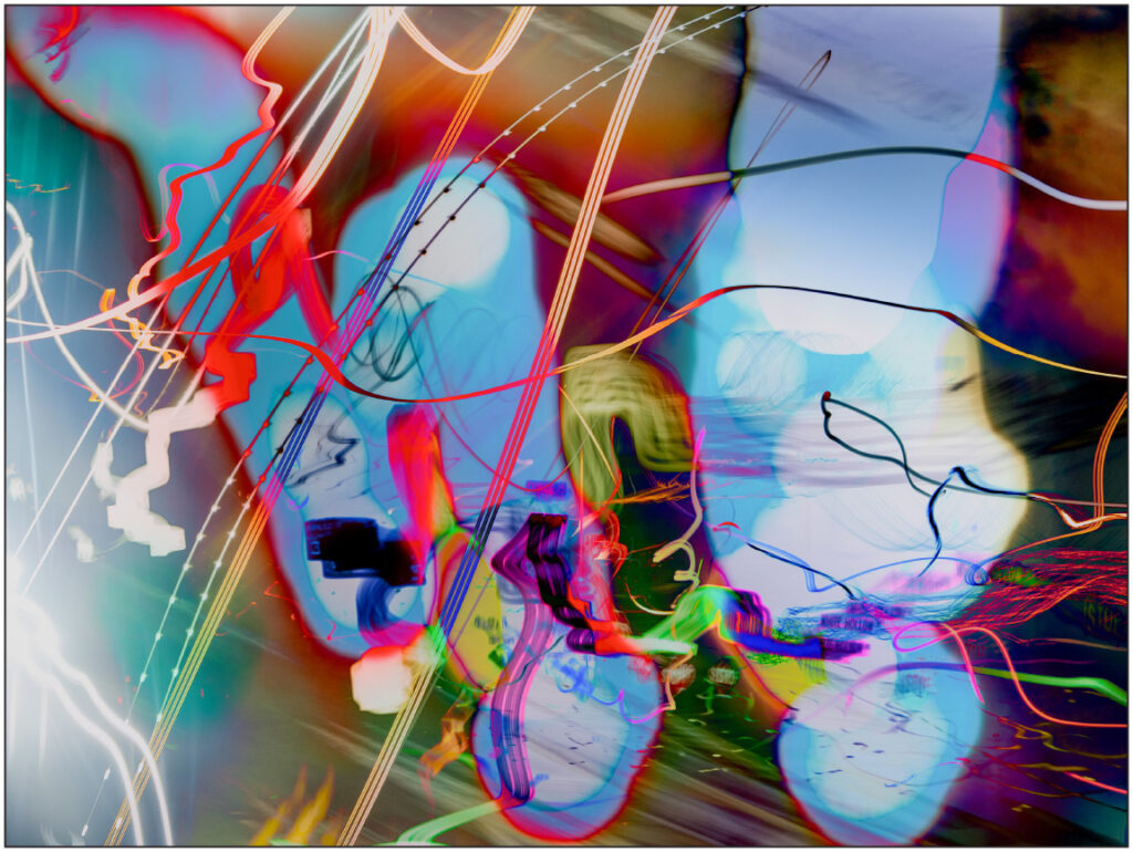 Abstract light painting image that looks like glowing graffiti with lots of blues and reds in varying shades